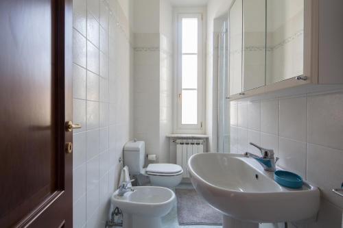 a white bathroom with a sink and a toilet at Punti di Vista in Portovenere