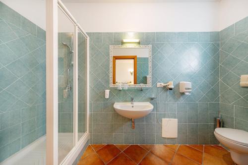 a bathroom with a sink and a mirror at Hotel San Trano in Luogosanto