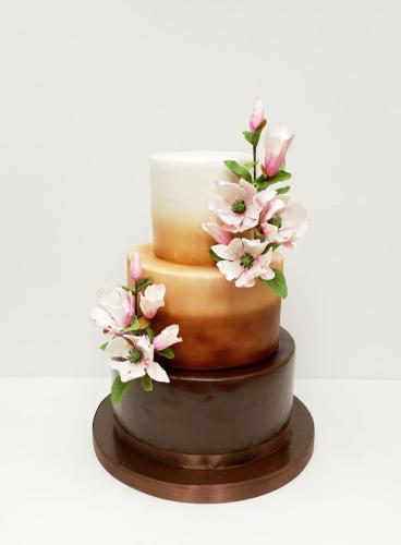 a cake with pink flowers on top of it at Hotel Select in Iaşi
