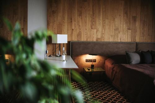 a bedroom with a bed and a table with a lamp at Lajvér Borbirtok in Szálka