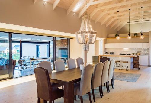 a dining room with a table and chairs at House 222 Gowrie Farm in Nottingham Road