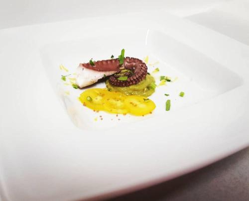a white plate with some food on it at Hotel Rodà in Panarea
