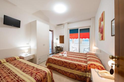 מיטה או מיטות בחדר ב-Hotel Stoccarda