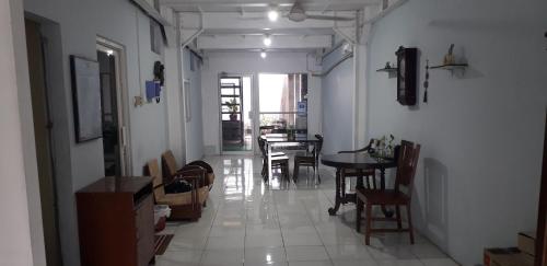 a hallway with a table and chairs in a room at Benara Shariah Homestay in Yogyakarta