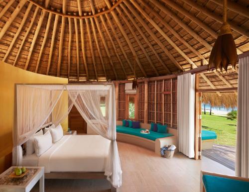 a bedroom in a villa with a bed at Jetwing Surf in Arugam Bay