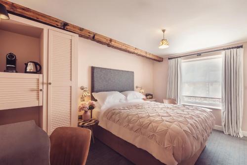 Ένα ή περισσότερα κρεβάτια σε δωμάτιο στο The New Inn