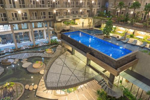an overhead view of a swimming pool in a building at Grande Valore Hotel Cikarang in Cikarang