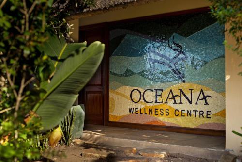 a sign that says oceana wellness center on a building at Oceana Beach and Wildlife Reserve in Port Alfred