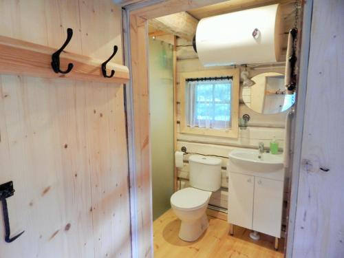 a bathroom with a toilet and a sink at Haaviku Nature Cottage in Tepelvälja