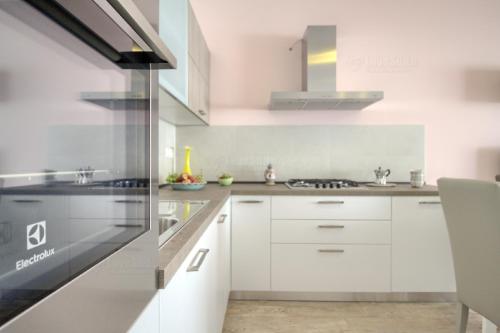a kitchen with white cabinets and a stove at Jacuzzi Holiday Homes by LoveSud in Leuca