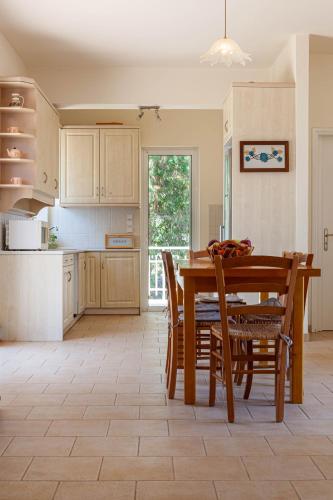a kitchen with a dining room table and chairs at VillaEvaNafplion in Paralía Iríon