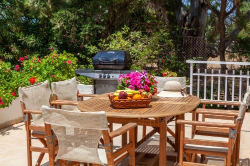 a table with a basket of fruit and a grill at VillaEvaNafplion in Paralía Iríon