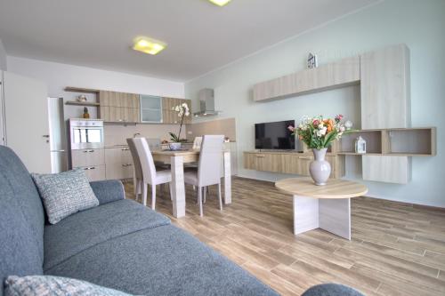 a living room and kitchen with a couch and a table at Jacuzzi Holiday Homes by LoveSud in Leuca