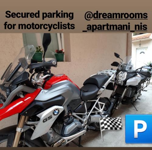 a red and silver motorcycle parked in a garage at Apartments & Dream Rooms in Niš