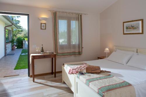 a bedroom with a bed and a table and a window at All'Antica Mattonata in Assisi