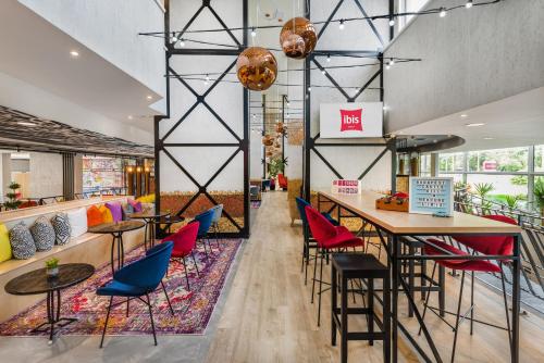 a restaurant with colorful chairs and a bar at ibis Budapest Castle Hill in Budapest