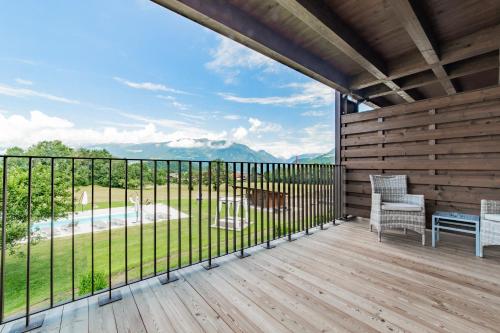 a balcony with a view of a pool and mountains at B&B Boutique Apartment Oberwiesen in Brunico
