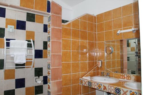 a bathroom with a sink and a mirror at Le Mas De Gleyzes B&B de Charme in Lédenon