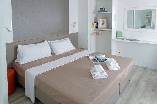 a bedroom with a bed with two towels on it at hu Roma Camping In Town in Rome