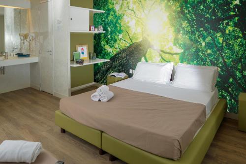 a bedroom with a bed with a green wall at hu Roma Camping In Town in Rome