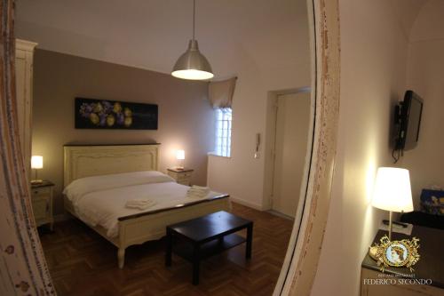 a bedroom with a white bed and white walls at Bed And Breakfast Federico Secondo in Palermo