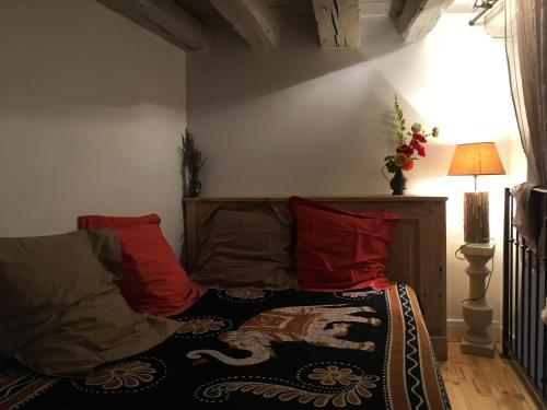a bedroom with a bed with red pillows at Les Allées de Bellecour in Lyon