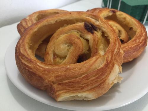 three pastries on a white plate on a table at Hotel-Pension KAMÝK in Prague