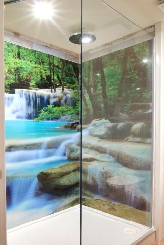 a mural of a waterfall in a room at Silver Street Suites in Whitby
