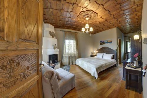 1 dormitorio con cama y techo de madera en Archontiko Naoumidi, en Portaria