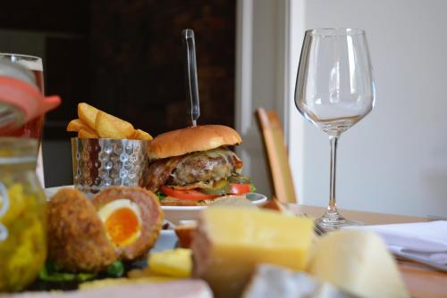 a plate with a sandwich and chips and a glass of wine at Stallingborough Grange Hotel in Stallingborough