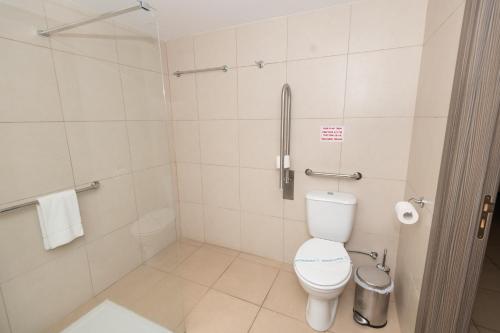 a bathroom with a toilet and a shower at Tofinis Hotel in Ayia Napa