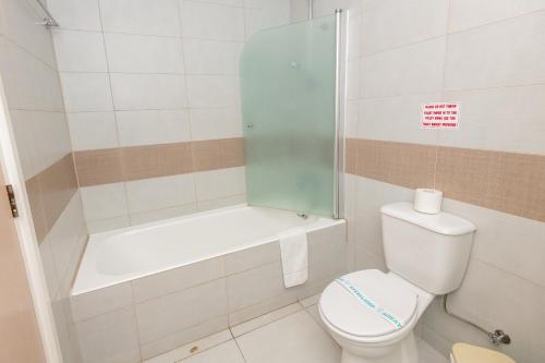 a small bathroom with a toilet and a shower at Tofinis Hotel in Ayia Napa