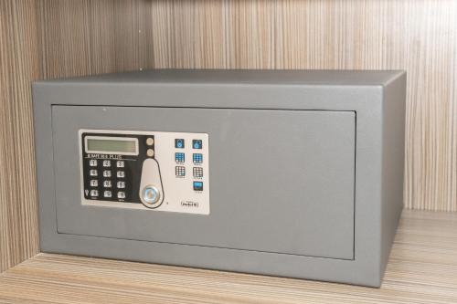 a microwave oven with a calculator on top of it at Tofinis Hotel in Ayia Napa