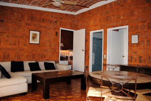 a living room with a couch and a table at Mama Chuy Hotel & Villas Ajijic in San Juan Cosalá