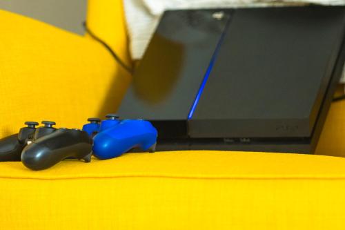 a pair of game controllers sitting next to a computer monitor at Villa Mamma Mia Oprtalj in Oprtalj
