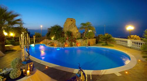 a large swimming pool in a resort at night at Hotel La Rosa Dei Venti in Campogrande
