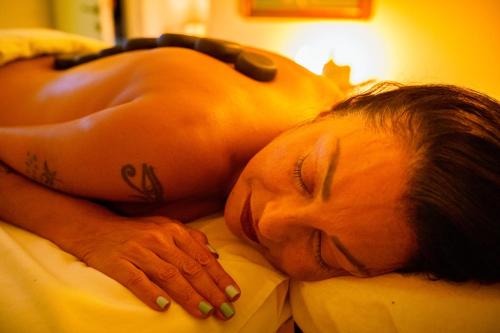 a man laying in bed with his head on a pillow at The Way Inn - Boutique Suites in Safed