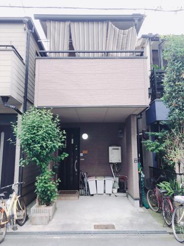 a house with bikes parked outside of it at Ryokoheya Awajikan in Osaka