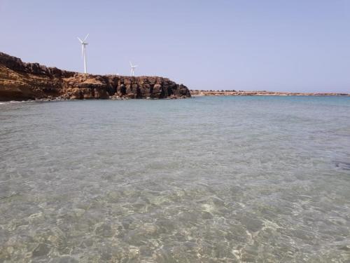 a large body of water with a rocky coastline at Villa Baya in El Haouaria