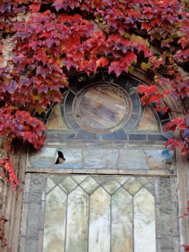 a door with red leaves on a building at Church Des Artistes in Kingston