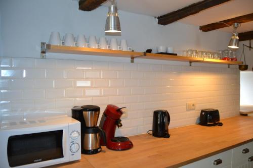a kitchen with a counter top with a microwave at Gitesonoro Beho in Gouvy