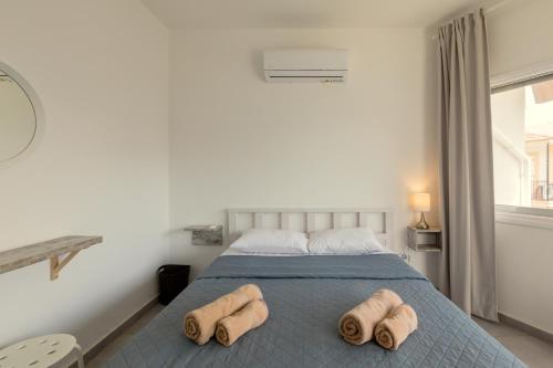 a bedroom with a bed with two towels on it at Andriana City Centre Flat in Larnaka
