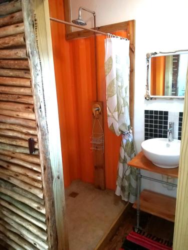 a bathroom with a sink and a toilet and a mirror at Blue Space Beach house in Port Shepstone