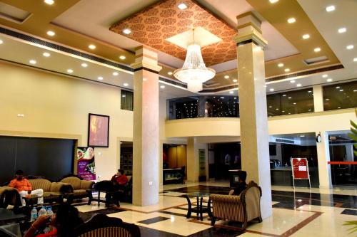 a lobby of a hotel with people sitting at Hotel City Inn in Varanasi