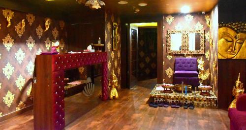 a room with a purple chair and a mirror at Hotel City Inn in Varanasi