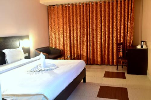 a bedroom with a bed with a candle on it at Hotel City Inn in Varanasi