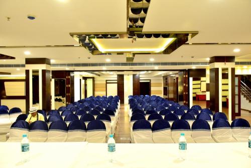 a room with blue and white chairs and water bottles at Hotel City Inn in Varanasi