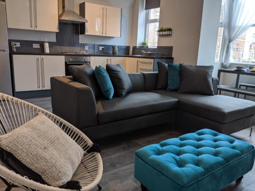 a living room with a couch and a table at Vibe Holiday Apartments in Blackpool