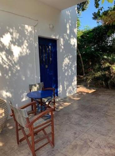 a patio with a blue table and a chair at Blue Sky in Ios Chora