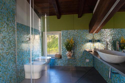 a bathroom with a tub and a sink and a toilet at Relais SANT'AMBROGIO in Bobbio